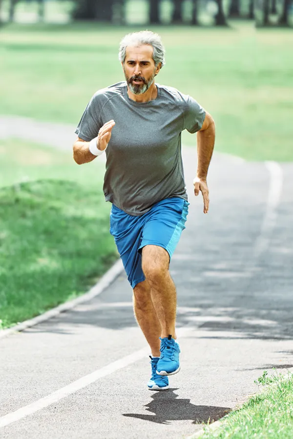 A man running on a track. Get treatment for ACL tears from Vitality Medical in Seattle.