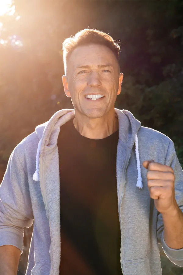 Bursitis-Treatment A smiling middle-aged man prepares for morning exercise. Get treatment for Bursitis from Vitality Medical in Seattle.