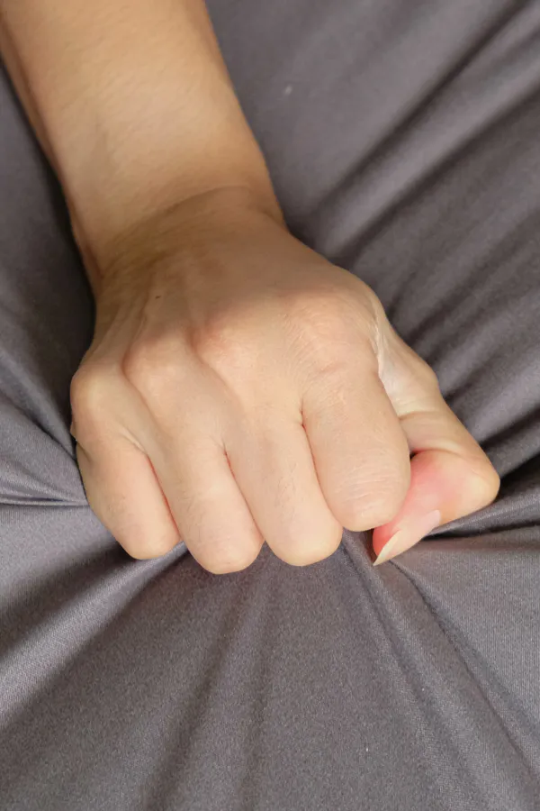 Female-Sexual-Dysfunction-Treatment Close-up of a woman's hand grabbing a sheet, indicating sexual pleasure. Get female sexual dysfunction treatment from Vitality Medical in Seattle.