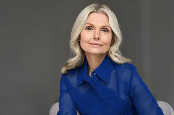 A mature woman with lustrous hair and skin. Get GHK-Cu peptides for skin and hair from Vitality Medical in Seattle.
