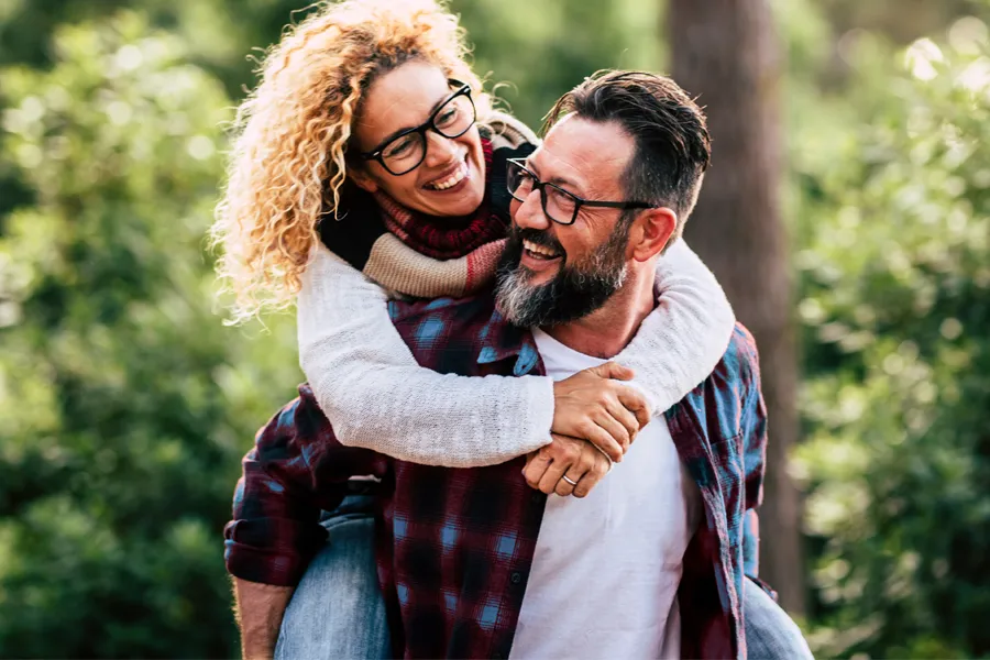 Methylene-Blue-Therapy-Doctor Happy middle-aged couple outdoors representing increased vitality and mental clarity from scheduling methylene blue therapy with Vitality Medical in Seattle.