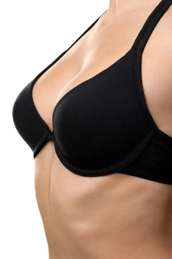 Close-up of a woman's chest wearing only a bra, showing the successful results of PRP breast lift treatment from Vitality Medical in Seattle.