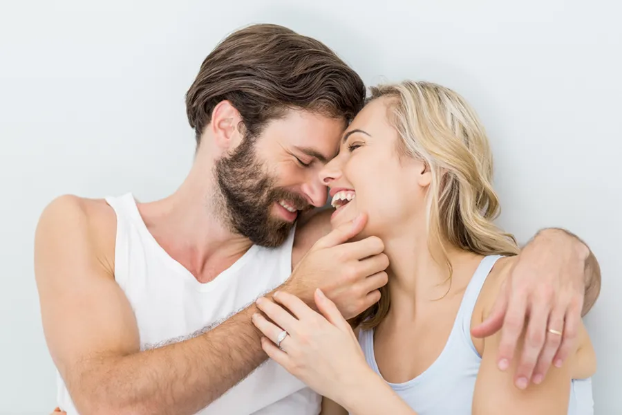 A joyful image of a couple playfully embracing each other. PRP for Erectile Dysfunction offered by Vitality Medical in Seattle.