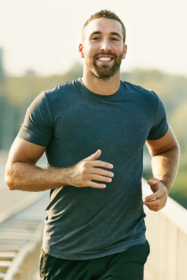 A man happily running for exercise. Get PRP for joint pain from Vitality Medical in Seattle.