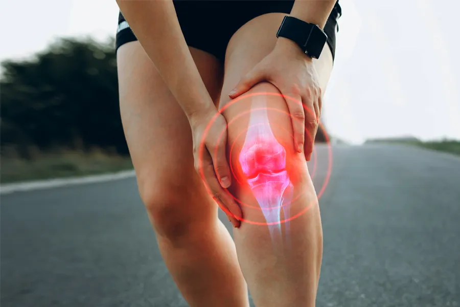 PRP-for-Knee-Injury-Doctor Close up of a female jogger holding her knee with an illustration of the knee joint with red radiating circles indicating pain, which can be relieved with PRP treatment for knee pain from Vitality Medical in Seattle.