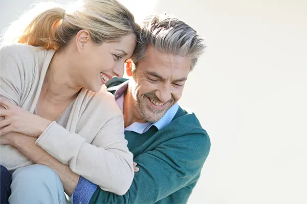 Vitality-Medical-Signature-Anti-Aging-Protocol-Clinic A happy middle-aged couple embrace in the sun. Get the Vitality Medical Signature Anti-Aging-Protocol from Vitality Medical in Seattle.