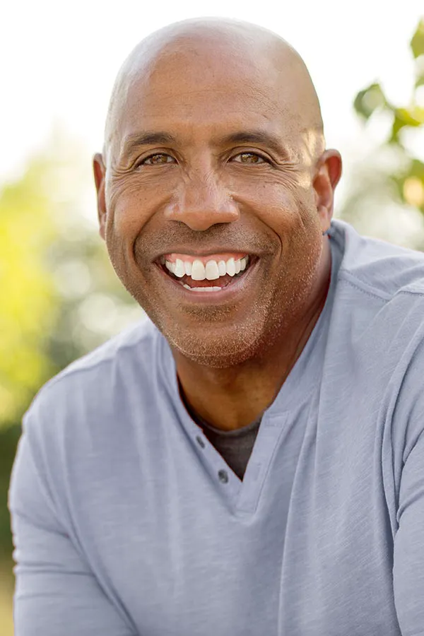 Vitality-Medical-Signature-Longevity Protocol-Treatment A happy middle-aged black man outside. Get the Vitality Medical Signature Longevity Protocol from Vitality Medical in Seattle.