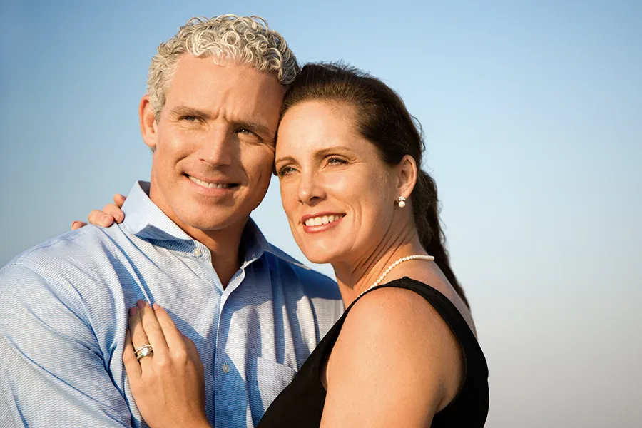 A happy middle-aged couple embrace and look to the horizon. Get the Vitality Medical Signature Senolytic Protocol from Vitality Medical in Seattle.