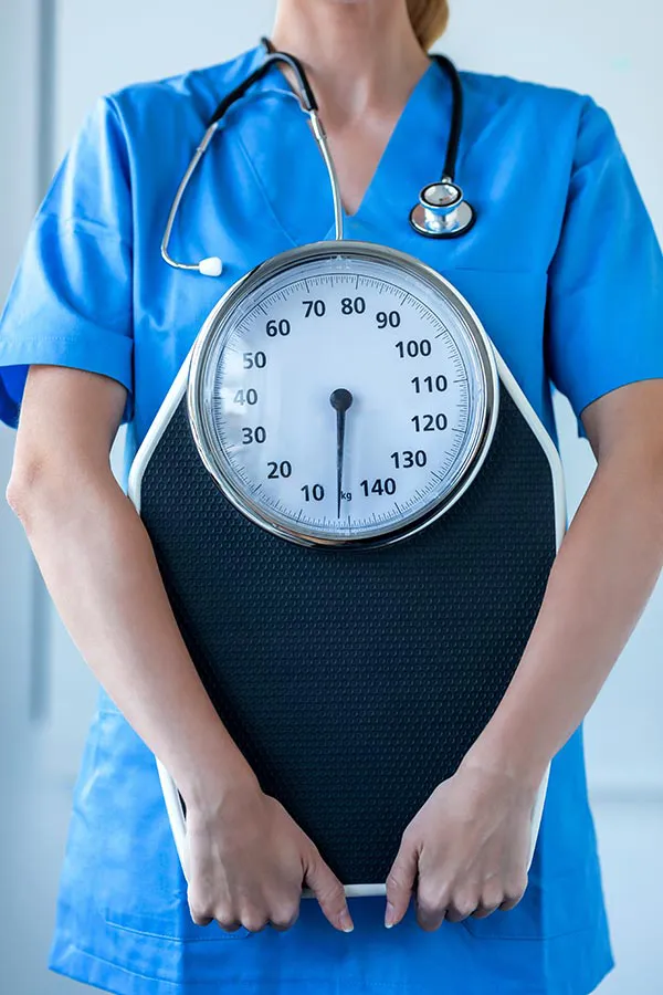 Vitality-Medical-Signature-Shreddage-Protocol-Treatment A clinician holds a scale. Get the Vitality Medical Signature Shreddage Protocol from Vitality Medical in Seattle.