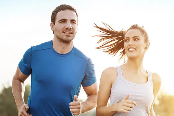 Weight-Loss-Resistance-Doctor A couple happily jogging in the sunlight after receiving effective weight loss resistance care from Vitality Medical in Seattle.